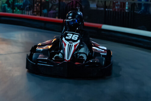 Everett Smith races a go-kart on the indoor track at K1 Speed Corona.