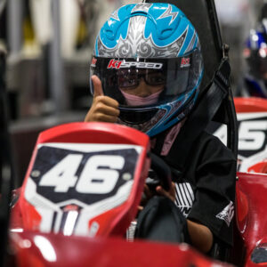 A junior driver gives a "thumbs-up" before racing at K1 Speed.