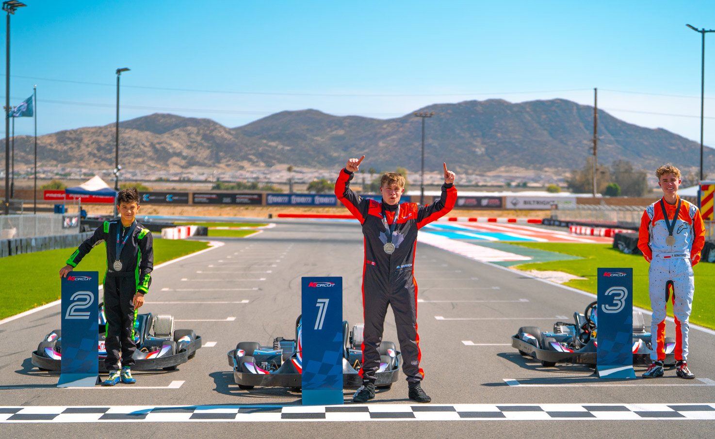 The teen world championship podium finishers lined up on-track.