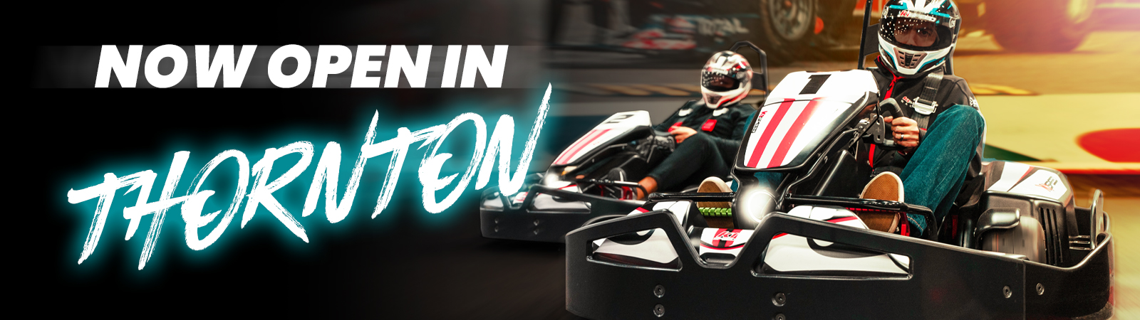 banner showing two people racing go-karts, text reads "now open in thornton"