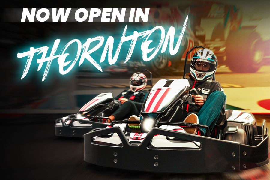 banner showing two people racing go-karts, text reads "now open in thornton"