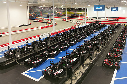 An overhead photo of go-karts in pit lane and an indoor karting track at K1 Speed Kansas City