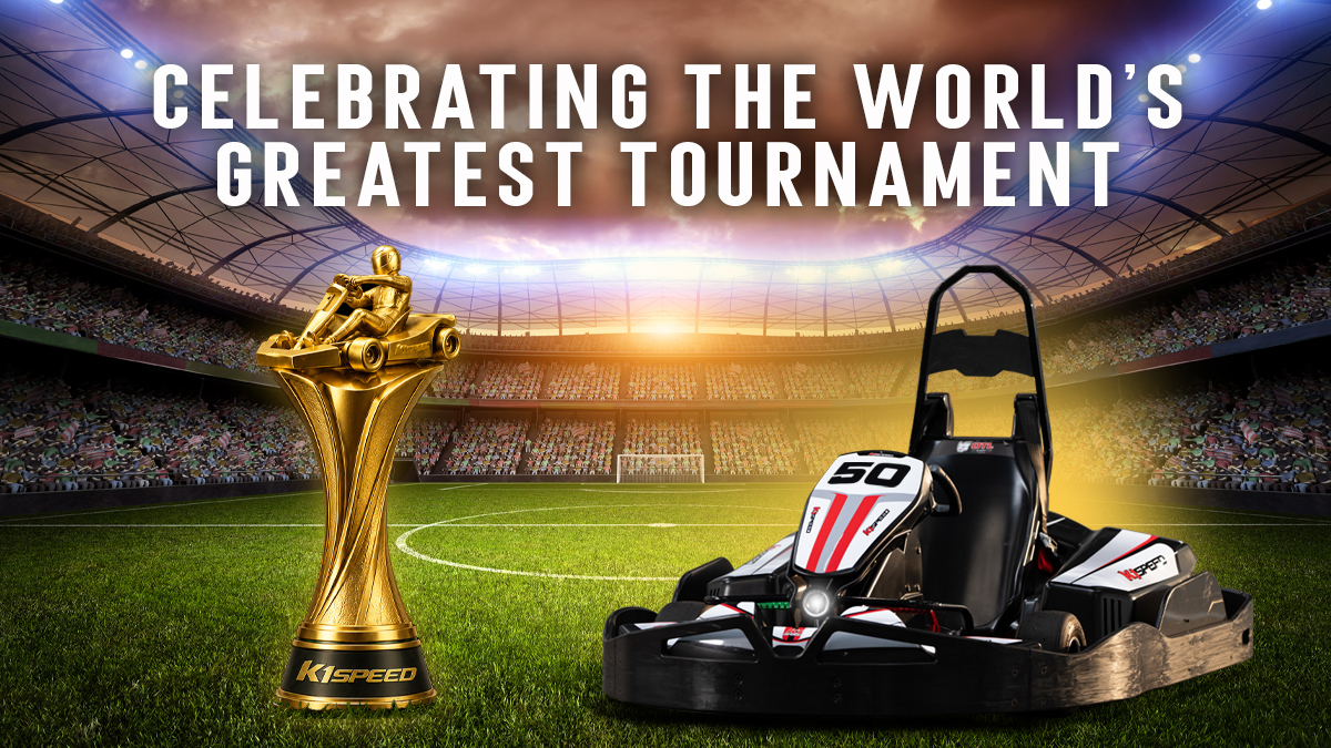 A go-kart sits next to a golden go-kart trophy in a soccer stadium, with text reading "celebrating the world's greatest tournament"