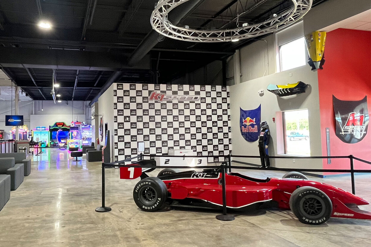 K1 Speed Cleveland Lobby featuring a podium and IndyCar on display
